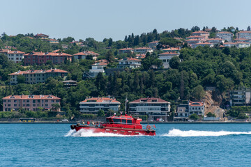 Red boat fast going on the sea