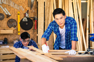 Carpenters are working in a wood factory. A carpenter or furniture maker made of wood.