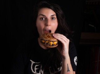 beautiful girl eating cheeseburger