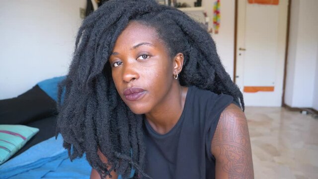 Slow motion shot of young woman with dreadlocks