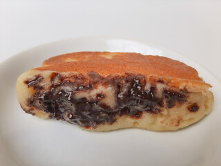 Pukis, is an Indonesian traditional pancake, with various toppings. On white plate. Isolated in white background.