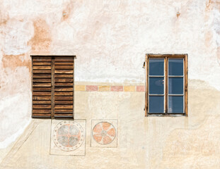 Wall and windows of an old medieval house on the street of the ancient city of Cesky Krumlov in the Czech Republic