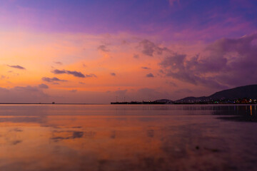 Burning bright sky during sunset on a tropical beach. Sunset during the exodus, the strength of people walking on water