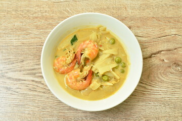 spicy boiled slice pickled bamboo shoot with shrimp and eggplant in coconut milk curry soup on bowl