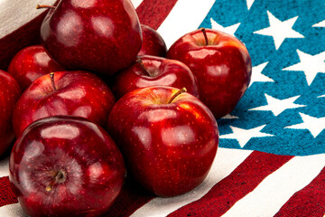 Red apples on a cotton cloth with United States of American flag pattern.