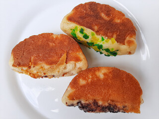 Pukis, is an Indonesian traditional pancake, with various toppings. On white plate. Isolated in white background.