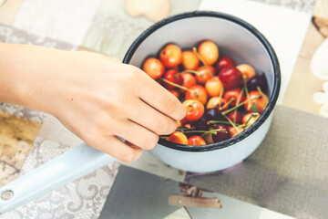 Young woman eating cherries