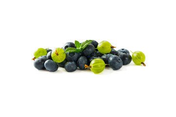 Berry isolation. Green and blue berries isolated on white background. Gooseberry and blueberry with copy space for text. Mixed berries isolated on white. Heap of berries on white background.