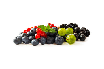 Berry isolation.Mix berries isolated on white background. Blueberry, currant, gooseberry and blackberry with copy space for text. Mixed berries isolated on white. Heap of berries on white background.