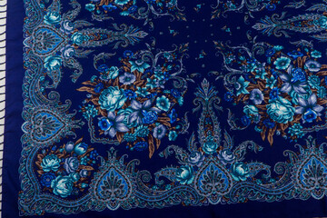 top view part of blue paisley floral pattern on dark cotton female shawl