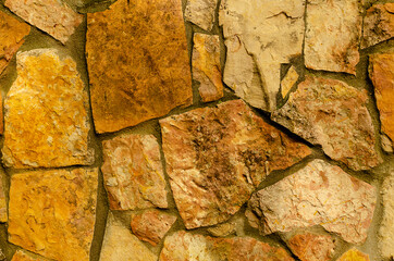 The texture of the masonry of yellow stones.