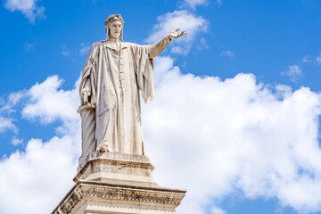 Fototapeta na wymiar Monument to Dante Alighieri a 19th-century statue of the poet Dante sculpted by Tito Angelini located in Plazza Dante Naples, Italy