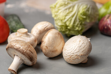 Fototapeta na wymiar Mushrooms are on the kitchen table among the vegetables