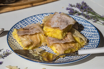 Homemade traditional Greek pastry -- Bougatsa made with phyllo dough and semolina custard cream.