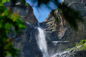 Naklejka na ściany i meble high in the mountains waterfall on the rocks