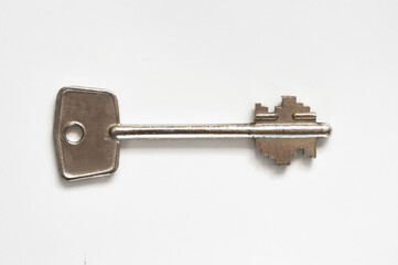 the key to the front door. metal key on a white background.