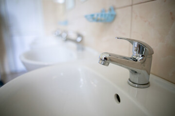 Bathroom interior with white sink and faucet