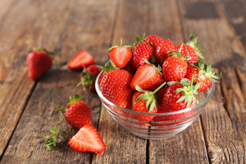 bowl of fresh strawberry on wood background