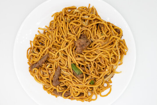 Above View of Beef Lo Mein Noodles on a White Plate with a White Background