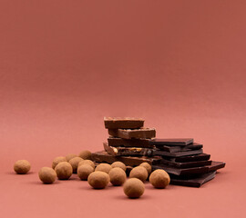 Pile of Chocolate background frame stock images. Different types of chocolate candies images. Assorted chocolate candies isolated on a brown background with copy space for text. Chocolate frame photo