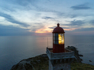 Lantern room of a lighthouse close up viewed from a drone in the dawn