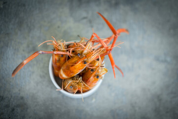 Thai style grilled river prawns served on white bowl cup