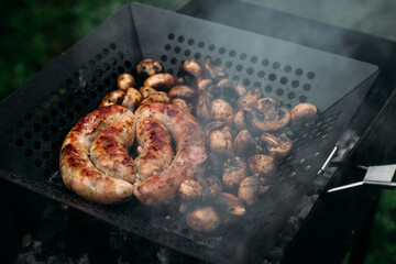 Grilled chicken sausage with mushrooms in a pan