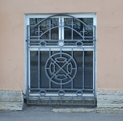 A basement window with a metal barrier