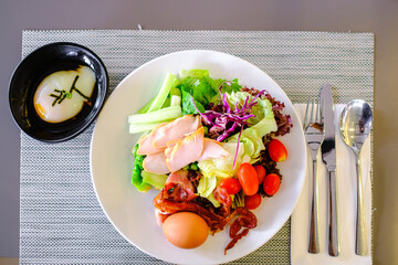 salad hot dog sushi in white plate and spoon with khife on the table
