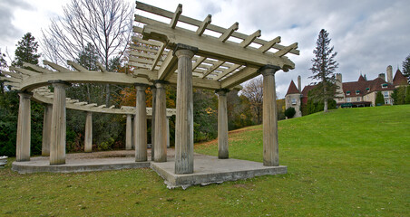Classic pergola in the foreground with the mansion in the background