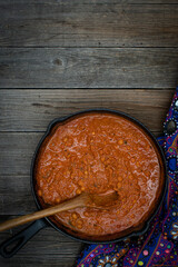 Indian chickpea garbanzo chole masala curry in cast iron pan, copy space