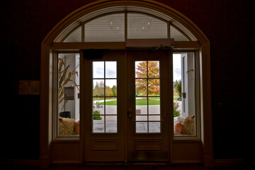Fototapeta premium Silhouette of french doors with autumn leaf color outside.