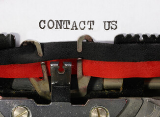 phrase CONTACT US on the typewriter