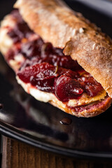 French baguette with hot Camembert cheese with jam