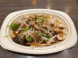 Northeastern style Spicy Papaya Salad and Vermicelli on a white dish
