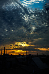 the sunset sky seen outside the window of a train running downtown Tokyo.