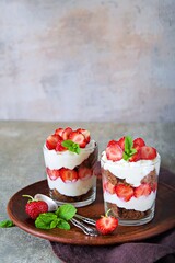 Dessert, truffle with chocolate biscuit, fresh strawberries and custard or cream cheese in glasses