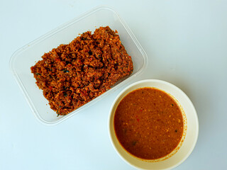 Sambel pecel or peanut sauce from Indonesia, for Indonesian salad. Comparison before and after diluted. Before diluted sauce is mashed solid peanut mixed with spices.