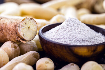 Brazilian manioc flour, called polvilho, manioc starch, carimã or gum, is the manioc starch. Rustic kitchen background with cookies around.