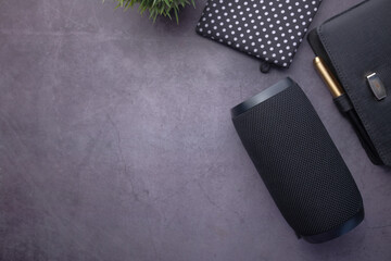smart speaker and notepad with copy space on black background 