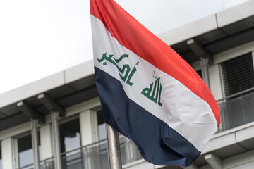 Flag of Iraq, including the three equal horizontal red, white, and black stripes of the Arab...