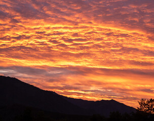 Colorful sunset in the mountains, mountains silhouettes at dusk
