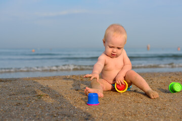little girl plays on a sandy beach