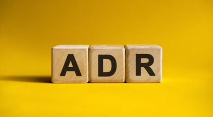 ADR text on a yellow background on wooden cubes