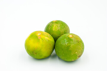 Green lemons on a white background