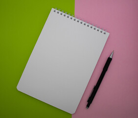 Stationery, laptop on a pink and green background. Back to school, workspace concept. Top view, flat lay, copy space, layout, layout