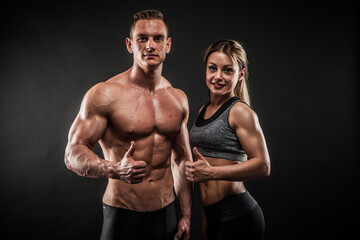 Fitness in gym, sport and healthy lifestyle concept. Couple of athletic man and woman showing their...