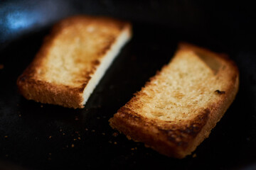 Fototapeta na wymiar Slices of bread in a pan. Toast the toast.