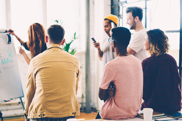 Back view of hipster guys listening training seminar during brainstorming in university.Diversity...