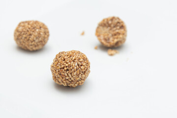Sesame seeds balls - sweet made with sesame and palm sugar. Tilgul Laddu or Til Gul balls for makar sankranti, Roasted thala balls. Indian snacks